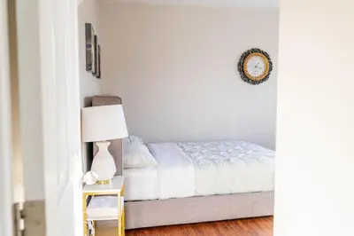 a bedroom with a bed and a table with a lamp at 1 BDR at heart of DT, walk to 2 metros, Concordia in Montréal