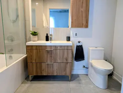 a bathroom with a sink and a toilet and a shower at Old Montreal Suite with Rooftop Pool & Terrace in Montréal
