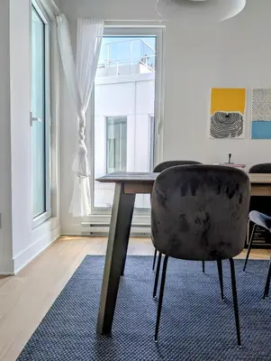 a dining room with a table and a chair at Old Montreal Suite with Rooftop Pool & Terrace in Montréal