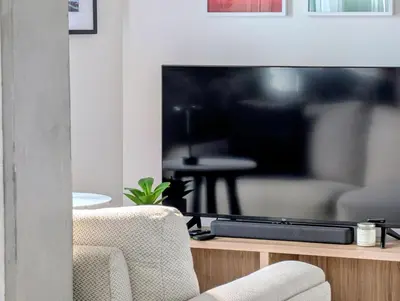 a living room with a large flat screen tv at Old Montreal Suite with Rooftop Pool & Terrace in Montréal