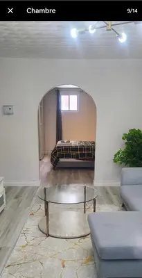 a living room with a bed and a coffee table at Private rooms in shared appartment in Montréal