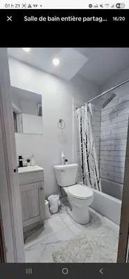 a bathroom with a toilet and a sink and a shower at Private rooms in shared appartment in Montréal