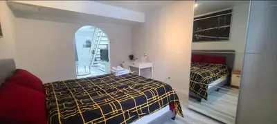 a bedroom with two beds and a mirror at Private rooms in shared appartment in Montréal