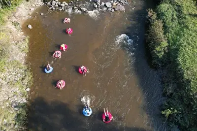 a group of people swimming in a river at Camping de la Rivière Nicolet in Wotton