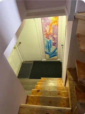 a view of a staircase with a painting on the wall at Studio moderne et tranquille in Montréal