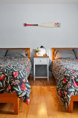 a bedroom with two beds and a table with a night stand at A Getaway on Lake Champlain in Venise-en-Québec