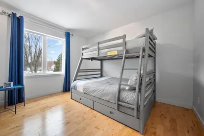 a bedroom with two bunk beds and a window at A Getaway on Lake Champlain in Venise-en-Québec