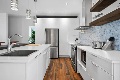 a kitchen with white countertops and a sink at A Getaway on Lake Champlain in Venise-en-Québec