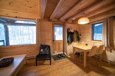 a dining room with a table and chairs in a cabin at Hotel de l'Horizon in Sutton