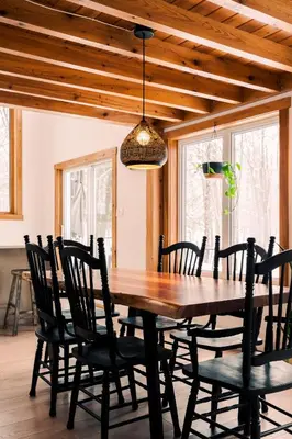 a dining room with a wooden table and chairs at Chalet Eastman in Eastman