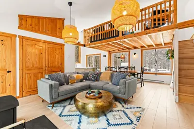 a living room with a couch and a table at Chalet Eastman in Eastman