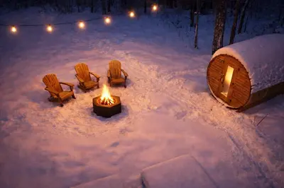 a fire pit in the snow with chairs and a tent at Chalet Eastman in Eastman