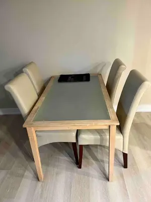 a wooden table with two chairs at Appartement privé et calme in Montréal