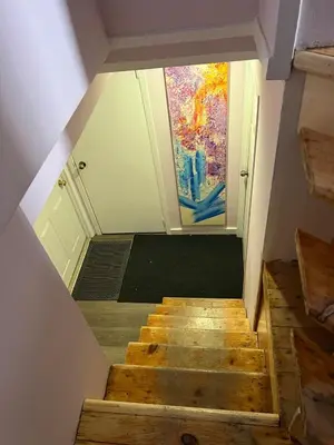 a staircase in a room with a painting on the wall at Appartement privé et calme in Montréal