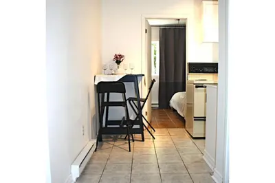 a small kitchen with a table and chairs at St-Denis II-8 Entire apartment at heart of MTL in Montréal