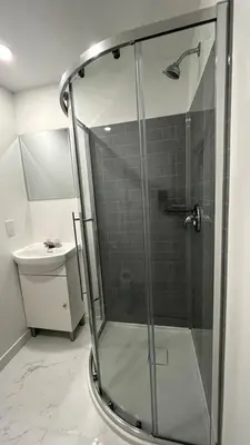 a glass shower in a bathroom with a sink at St-Denis II-8 Entire apartment at heart of MTL in Montréal