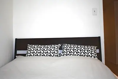 a bed with black and white pillows in a bedroom at St-Denis II-8 Entire apartment at heart of MTL in Montréal