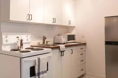 a kitchen with a white stove and a microwave at St-denis II-3 Apt In the heart of Montreal in Montréal