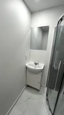 a white bathroom with a sink and a shower at St-denis II-3 Apt In the heart of Montreal in Montréal