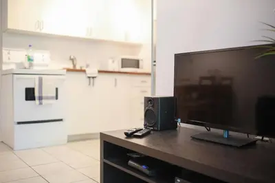 a living room with a large screen television on a table at St-denis II-3 Apt In the heart of Montreal in Montréal