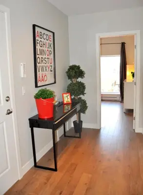 a living room with a table with plants on it at Le Mont-Royal Lounge by HomeInMontreal in Montréal