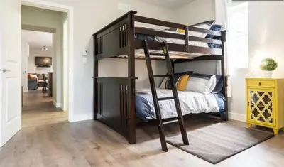 a bedroom with a bunk bed with a ladder at Le Mont-Royal Lounge by HomeInMontreal in Montréal