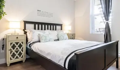 a bedroom with a large bed and a window at Le Mont-Royal Lounge by HomeInMontreal in Montréal