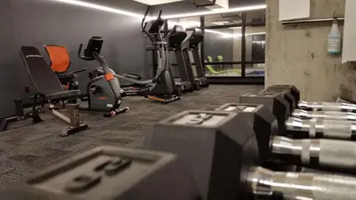 a gym with several chairs and exercise bikes at Grand Times Hotel Drummondville in Drummondville