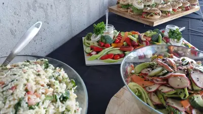 a table topped with bowls of different types of food at Grand Times Hotel Drummondville in Drummondville