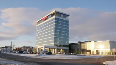 a tall building with a sign on top of it at Grand Times Hotel Drummondville in Drummondville