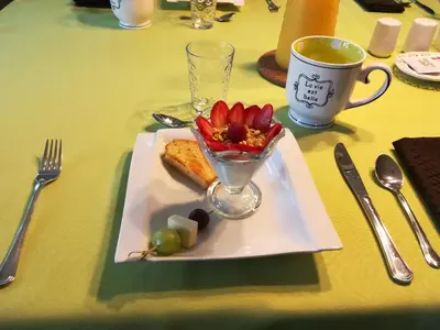 a plate of food on a table with a cup of coffee at Lecomte De La Fontaine in North Hatley