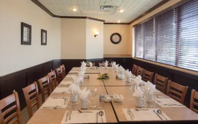 a dining room with a long table and chairs at La Porte de la Mauricie in Louiseville