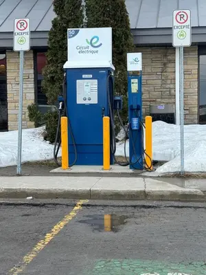 a blue gas pump on the side of a street at La Porte de la Mauricie in Louiseville