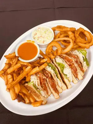 a plate with a sandwich and french fries and coleslaw at La Porte de la Mauricie in Louiseville