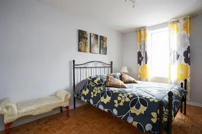 a bedroom with a bed and a window at Big Cozy House in Montréal