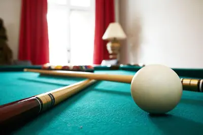 a pool table with billiard balls and cues on it at Big Cozy House in Montréal