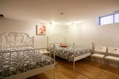 a bedroom with two beds and a window at Big Cozy House in Montréal