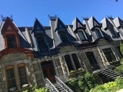 a house with a bunch of roofs on it at L'Adresse Botanique - Studio in Montréal