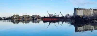a large boat is docked in a body of water at L'Adresse Botanique - Studio in Montréal