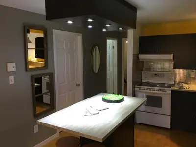 a kitchen with a table with a cake on it at La Maison des Éboulis in Victoriaville