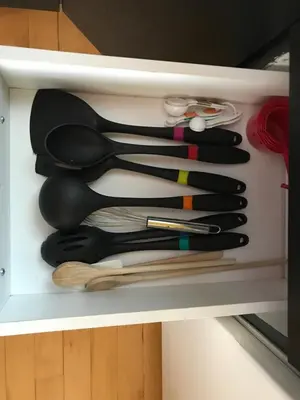 a group of utensils sitting on a shelf at La Maison des Éboulis in Victoriaville