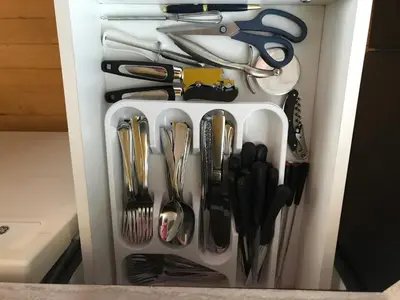 a drawer filled with utensils in a kitchen at La Maison des Éboulis in Victoriaville