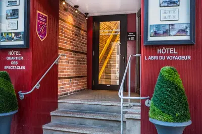 a door to a hotel with twoiaries in front of it at Hotel Abri du Voyageur in Montréal