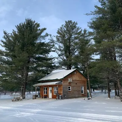 a small wooden house with a snow covered roof at Chalets du Domaine Yamaska in Bromont