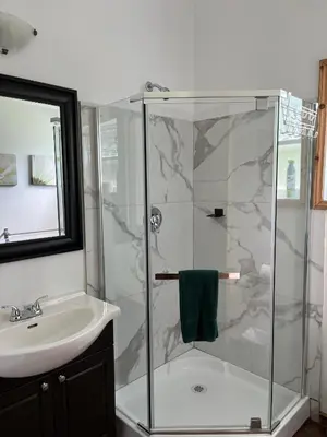 a bathroom with a shower and a sink at Chalets du Domaine Yamaska in Bromont