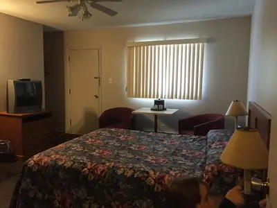 a hotel room with a bed and a television at Hotel Motel Arnold in Woburn