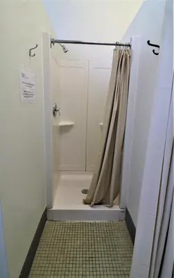 a bathroom with a shower with a shower curtain at The Grey Nuns Residence by Concordia University in Montréal
