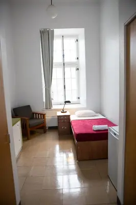 a small bedroom with a bed and a window at The Grey Nuns Residence by Concordia University in Montréal
