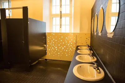 a row of sinks in a public bathroom at The Grey Nuns Residence by Concordia University in Montréal