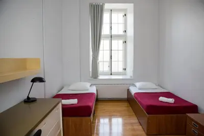 two beds in a small room with a window at The Grey Nuns Residence by Concordia University in Montréal